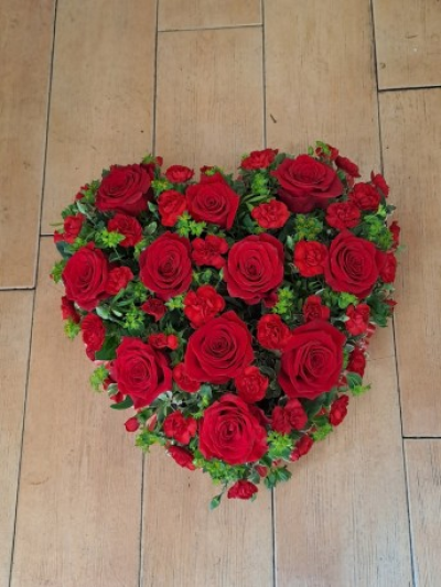 Red Rose & Carnation Heart - A traditional heart design made with roses and carnations with foliage.